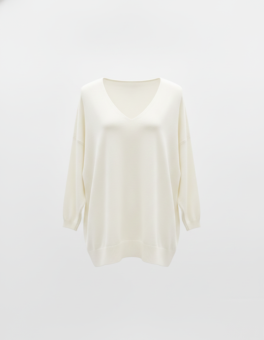 White V-neck knit top with ribbed hem hanging on a wooden hanger