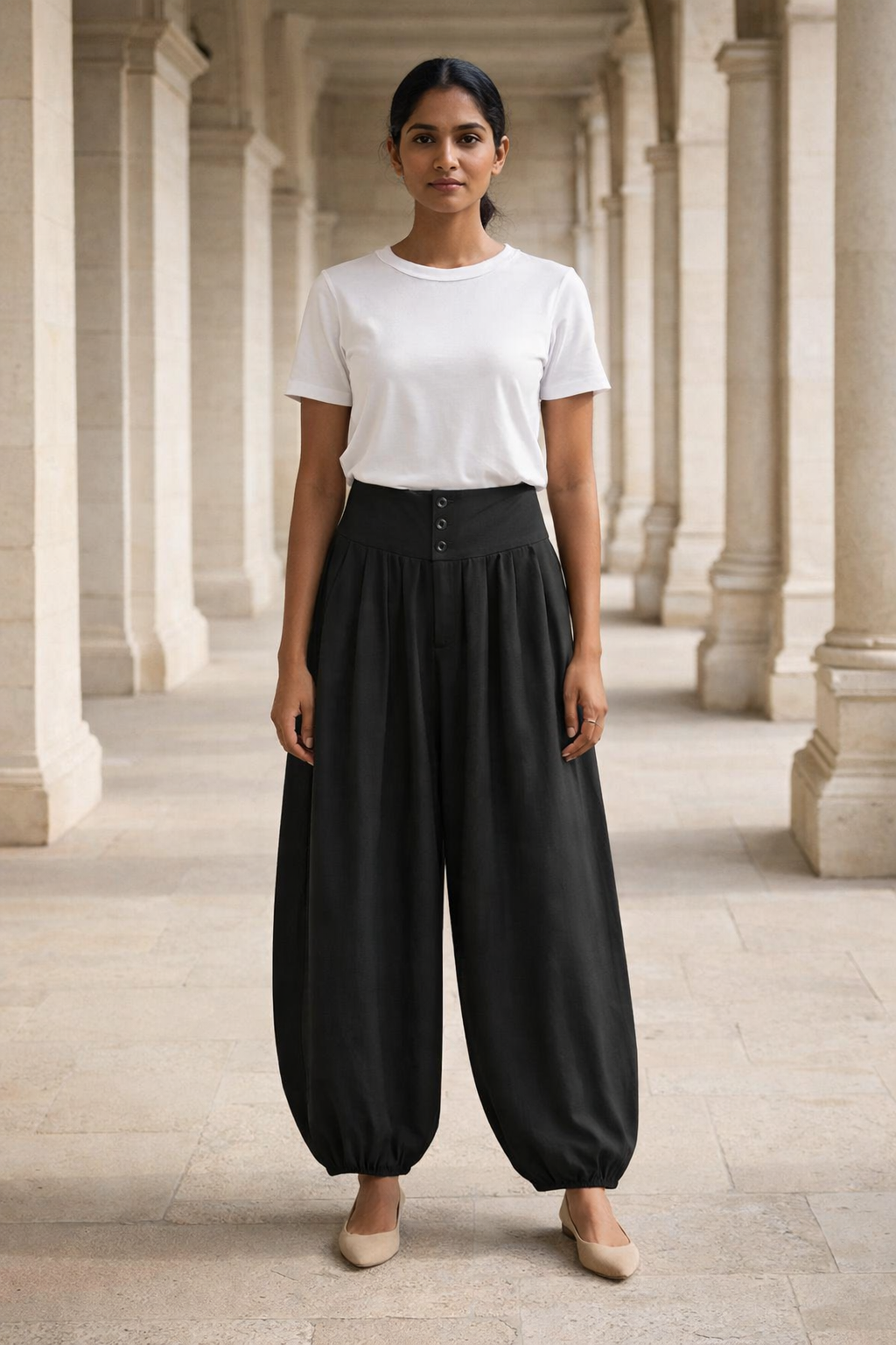 Black high-waist baggy trousers with button detailing on the waistband and elasticated hems