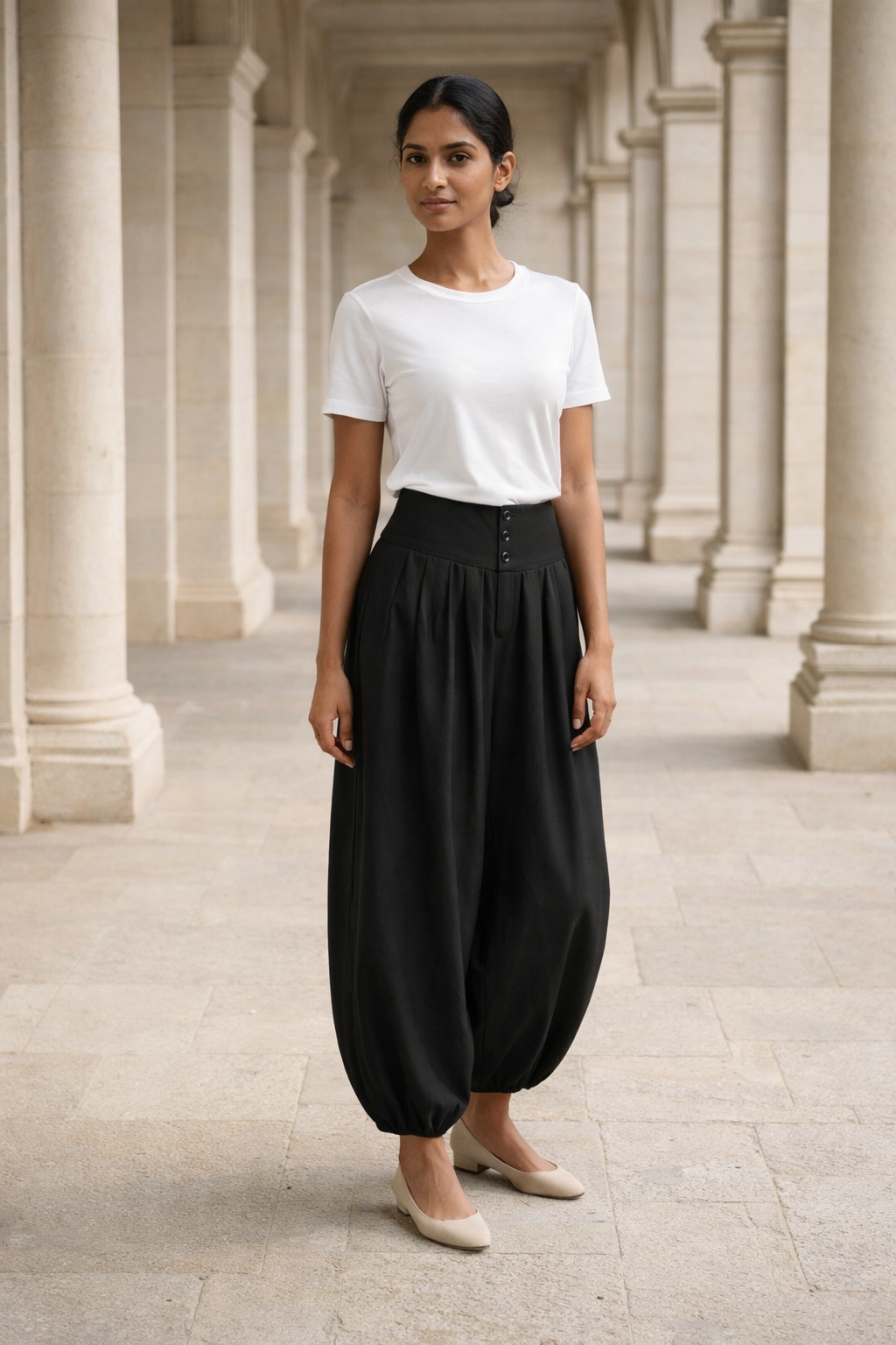 Black high-waist baggy trousers with button detailing on the waistband and elasticated hems