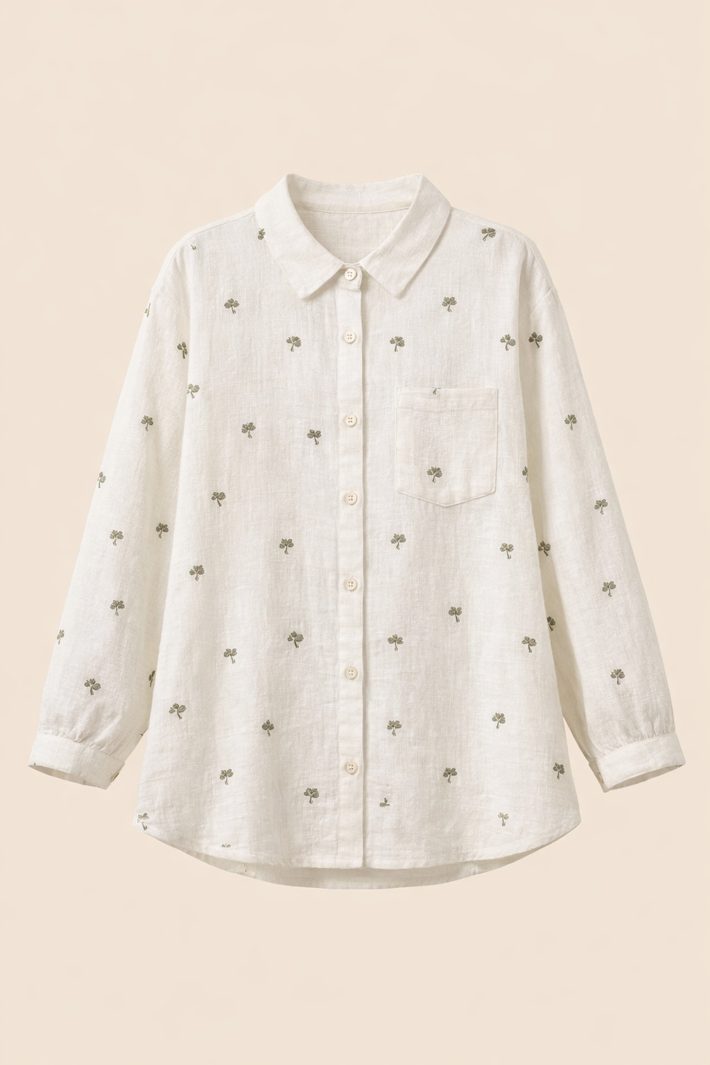 White women’s long sleeve shirt with collar and button placket, featuring subtle green leaf print all over and single chest pocket